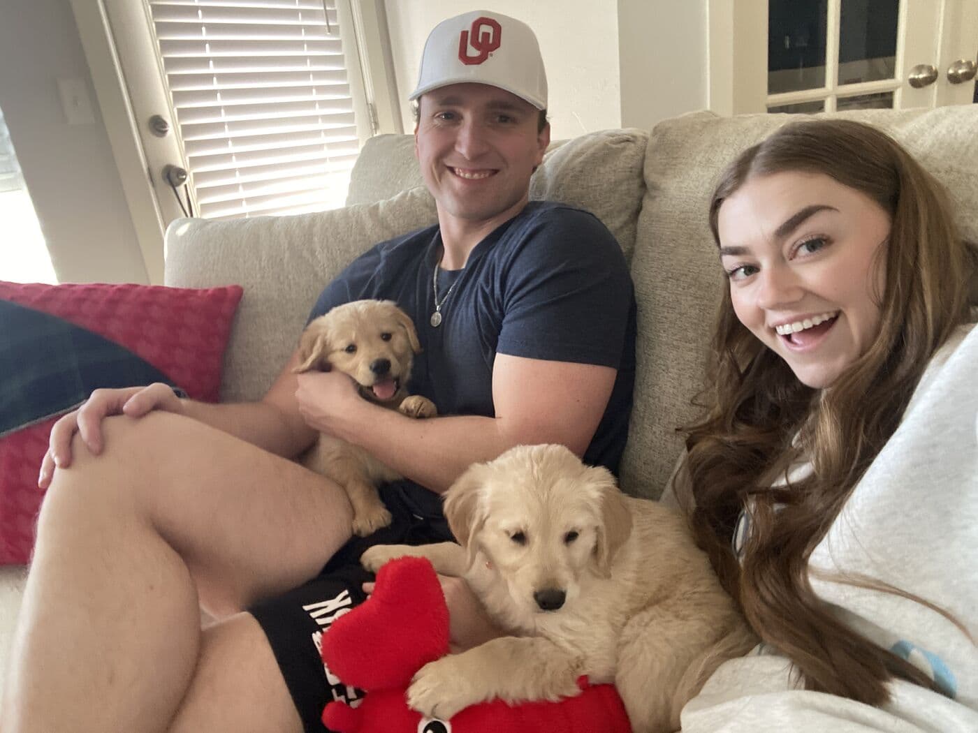 Elise and Tyler on the couch on the day they brought Archie home