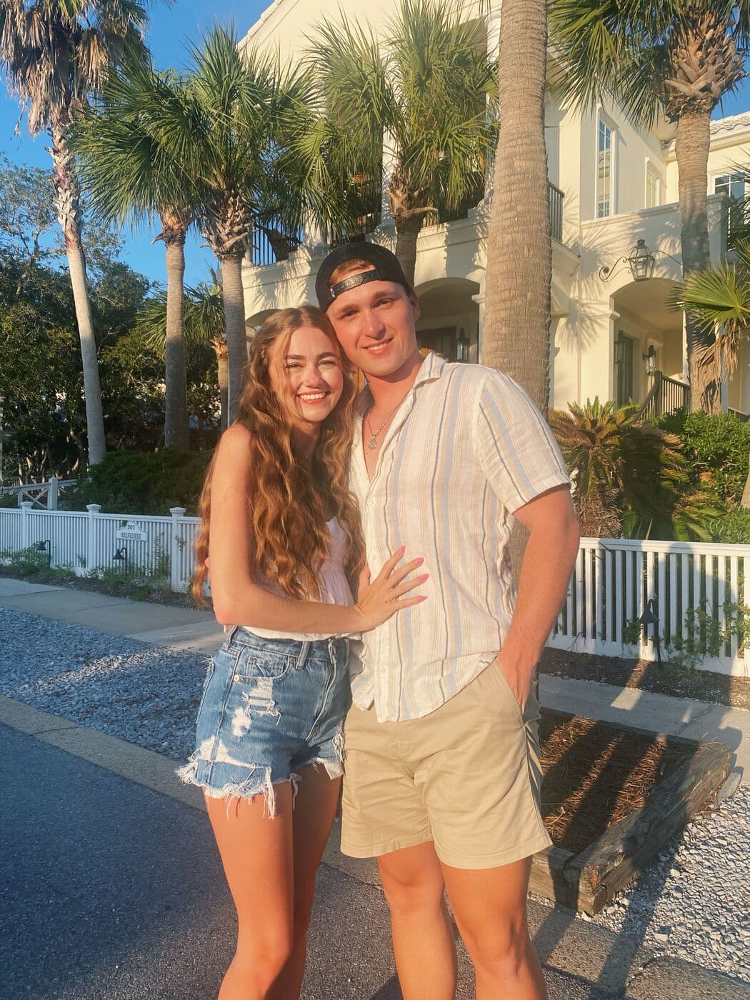 Elise and Tyler under the palms on a Carillon Beach street